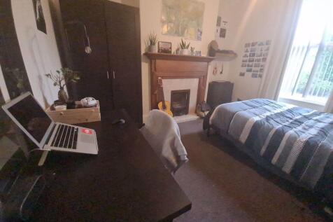 A cozy and well-maintained bedroom featuring a ...