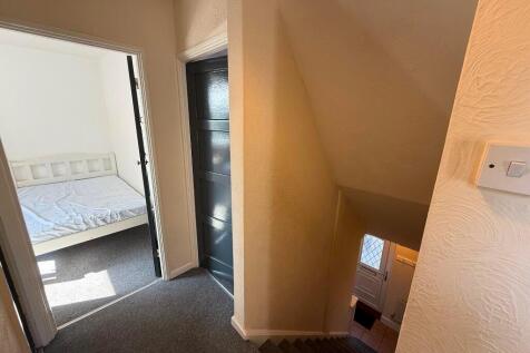 Bright first-floor landing with carpeted stairs...