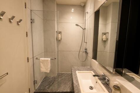 Modern bathroom with walk-in shower and vanity...