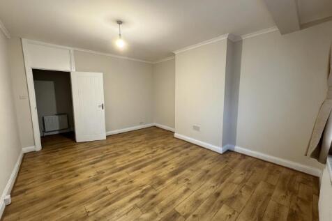Bright, neutral living room with wood-effect fl...