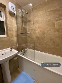 Freshly Tiled Bathroom With Shower Over Bath