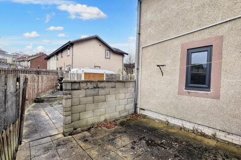 Flagged garden that wraps around the rear of the property