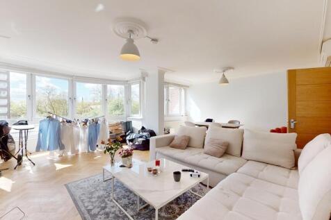 Bright, airy lounge with large windows and sofa...