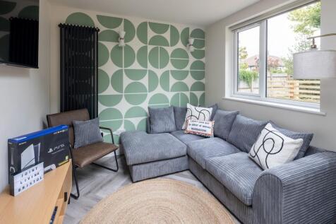 Stylish lounge with plush sofa and feature wall...