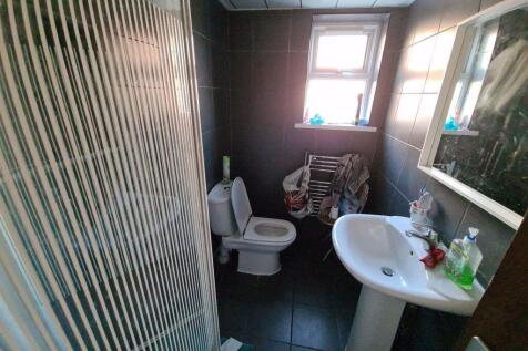 A compact, well-maintained bathroom featuring a...