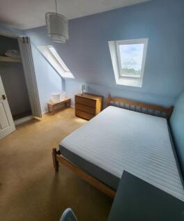 Bright attic double bedroom with two skylight w...