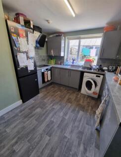 Modern kitchen with sleek grey units and large ...