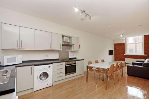 Bright open-plan kitchen and dining area with s...