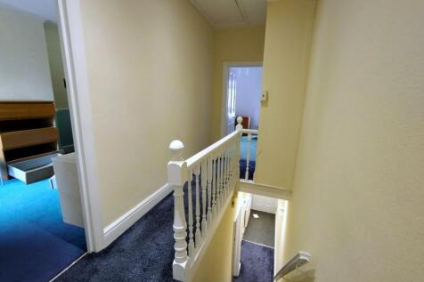 Bright and tidy landing with plush dark carpet...