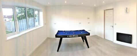 A bright and inviting cinema room featuring a s...