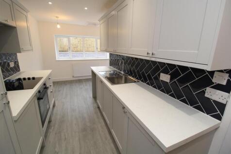 Modern kitchen with stylish dark tiling....