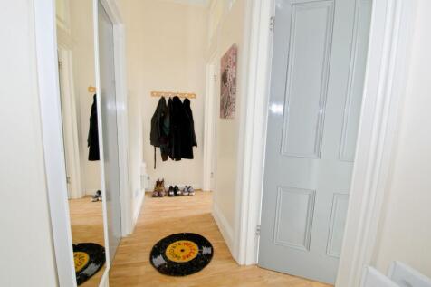 Bright, tidy hallway with light wood flooring, ...