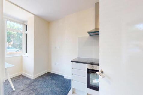 Bright compact kitchen with a windowed breakfas...