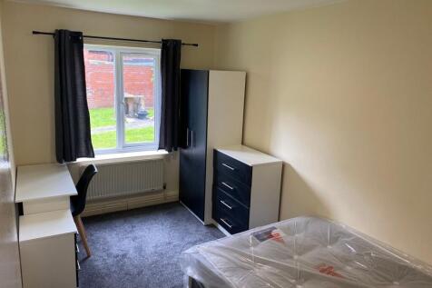 Bright and tidy single bedroom featuring a wind...