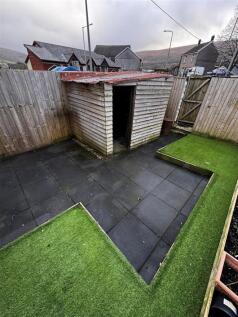 Private paved garden with artificial lawn...