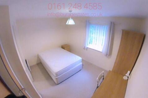 Bright, simply furnished bedroom with a neatly ...