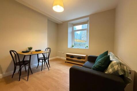 Bright, simply furnished living room featuring ...