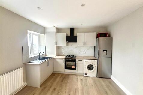 Bright modern kitchen with integrated appliance...