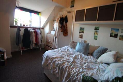 A spacious and bright master bedroom featuring ...