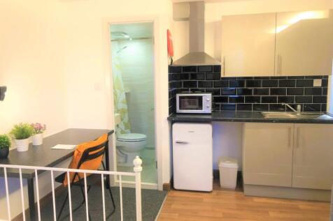 Bright and tidy living space featuring a compac...