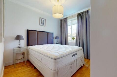 Bright, neatly styled double bedroom with a com...