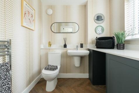 A combined cloakroom and utility adds convenience