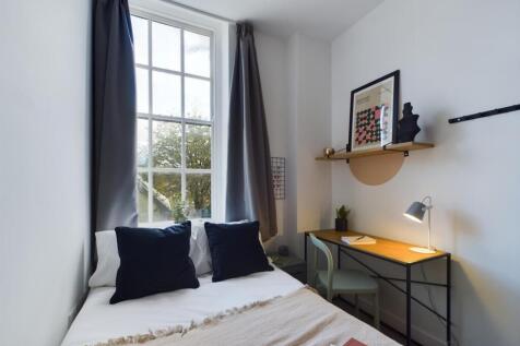 A cozy and well-lit double bedroom featuring a ...