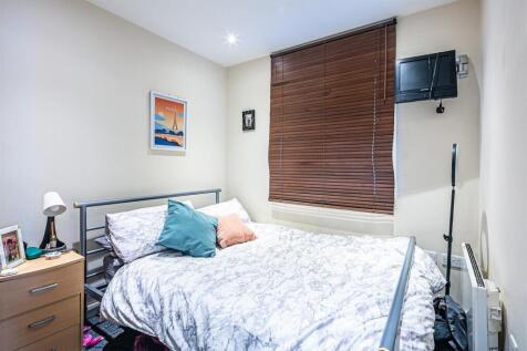 Bright double bedroom with wall-mounted TV...