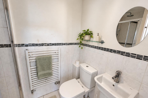 Subtly staged bathroom with sage accents.png