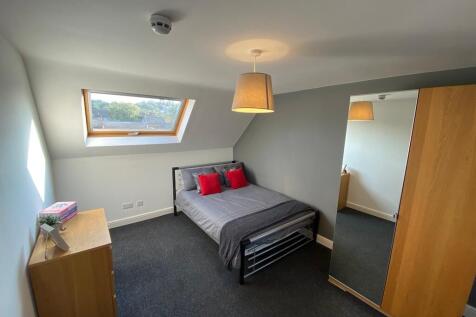 Bright, modern double bedroom with a skylight w...