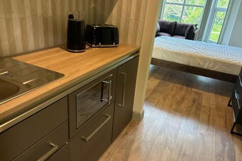 Modern kitchen area with integrated appliances...