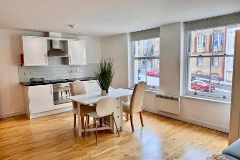 Bright open-plan kitchen with large windows....