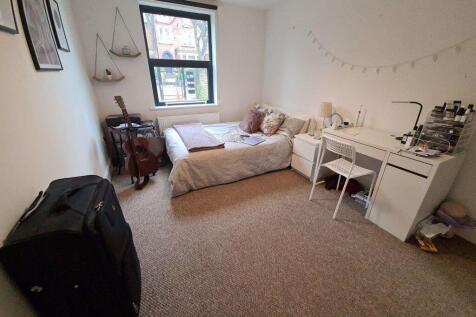 Cozy single bedroom featuring a comfortable bed...