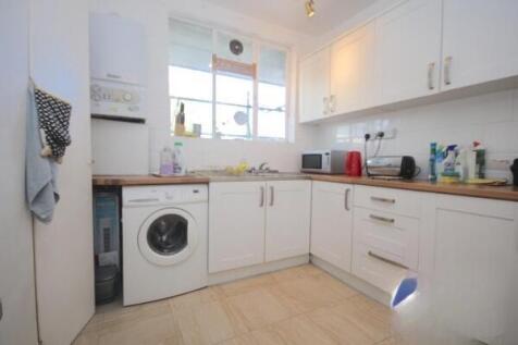 Bright kitchen with modern white cabinetry...