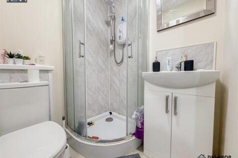 Modern ensuite with sleek corner shower unit...
