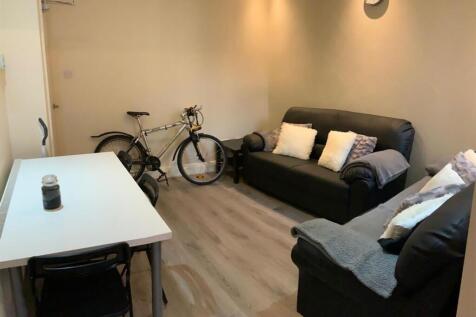 Cozy living room with comfy sofas and dining ta...
