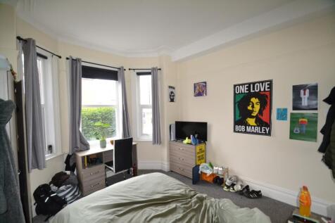 This inviting double bedroom features large win...