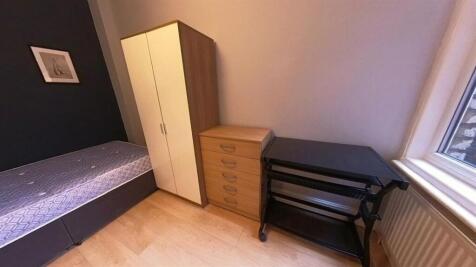 Neat furnished bedroom with a single bed, wardr...