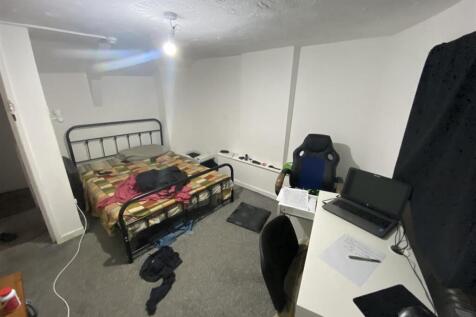 Spacious bedroom with double bed and desk area...