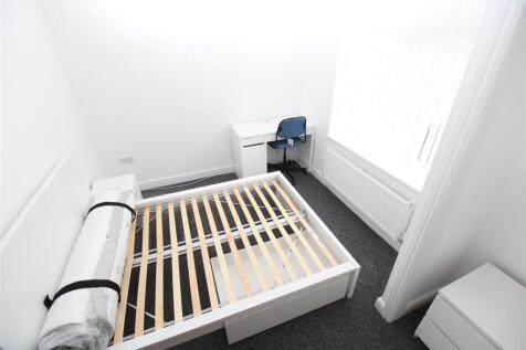 Bright bedroom with desk and natural light...