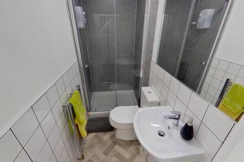 Modern bathroom with sleek walk-in shower...