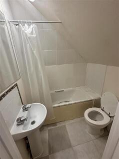 Bright bathroom with a full bathtub and tiles...