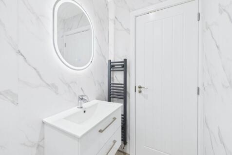 Modern and sleek bathroom featuring a well-lit ...