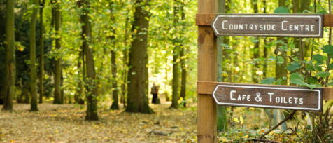 Two signages in the forest Country Park showing direction for Countryside Centre at Alconbury Weald