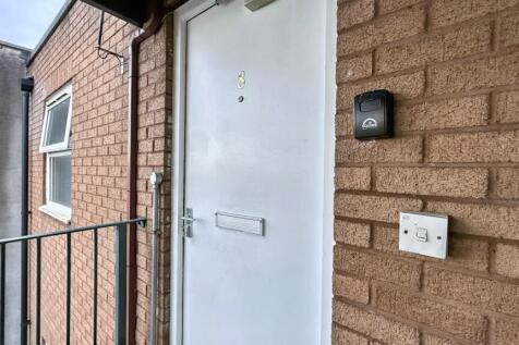 Secure front entrance with a modern white door...