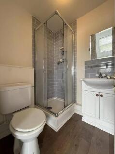 Bright bathroom with modern grey subway tiling...