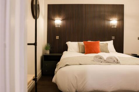 Stylish bed with modern wood panel headboard...
