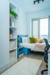 Bright modern bedroom with ample storage space...