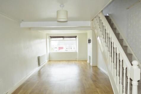 Bright and airy open living space with wood flo...