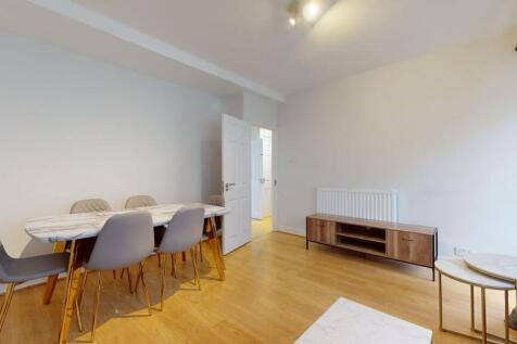 Bright living area with modern dining set...